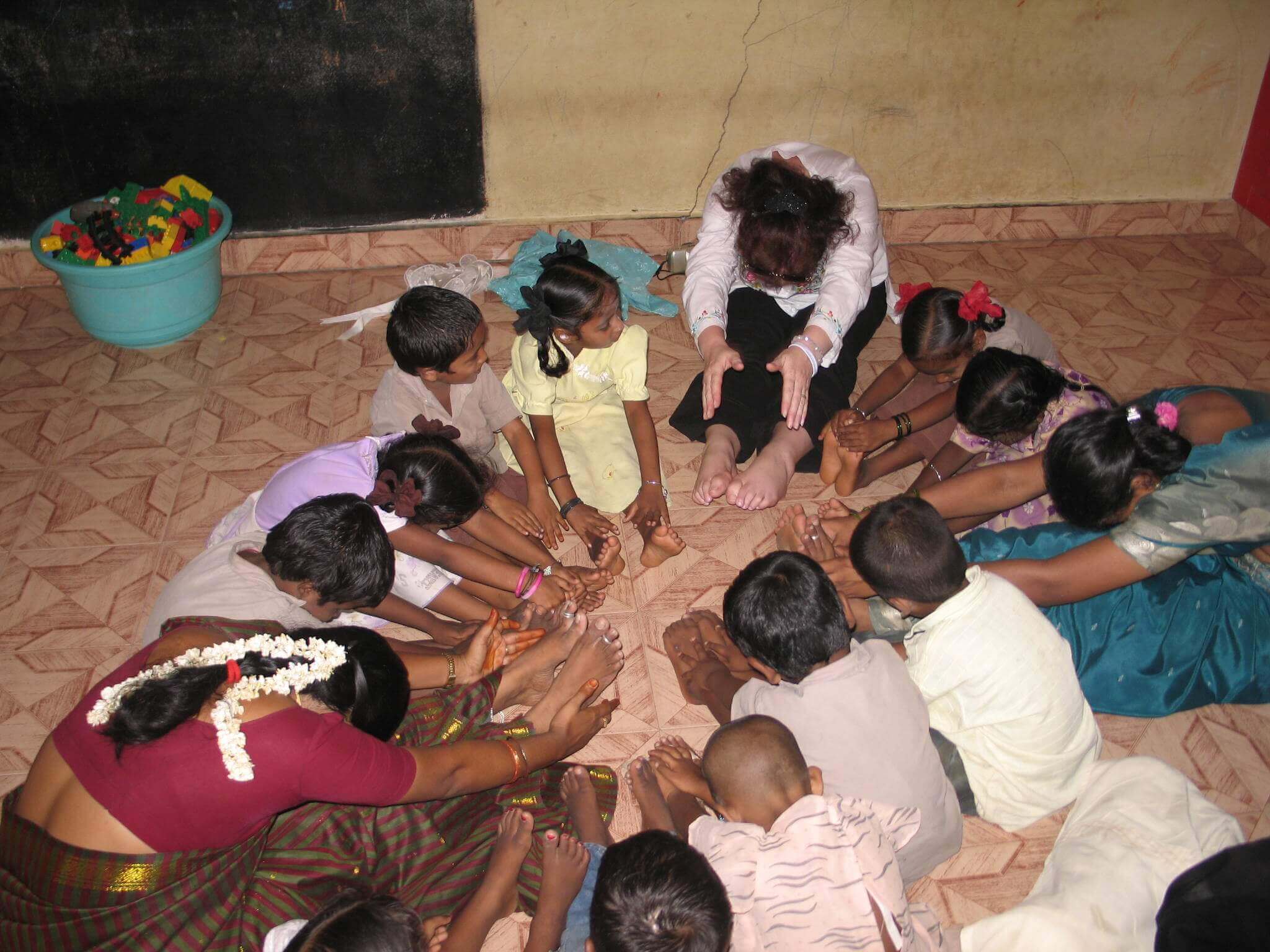 Staff, overseas volunteer and children performing excercises