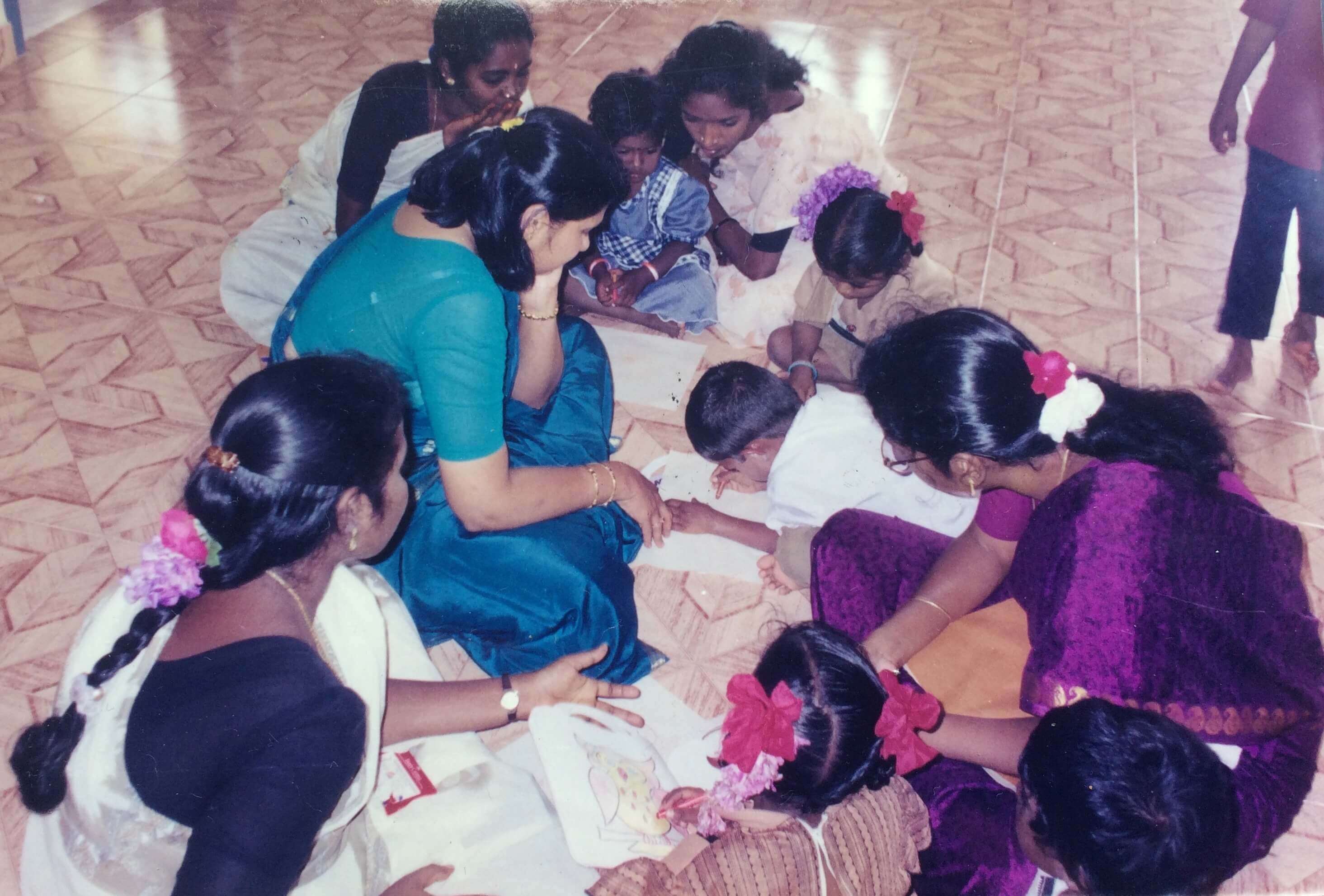 Children learning to draw and colour at Child Development Centre in Irumaram